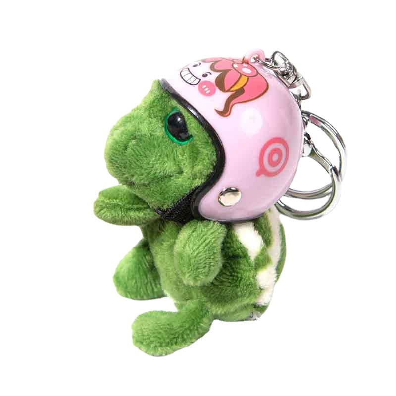 A green plush turtle keychain wearing a pink helmet with cartoon graphics, attached to silver metal key rings, on a plain white background.